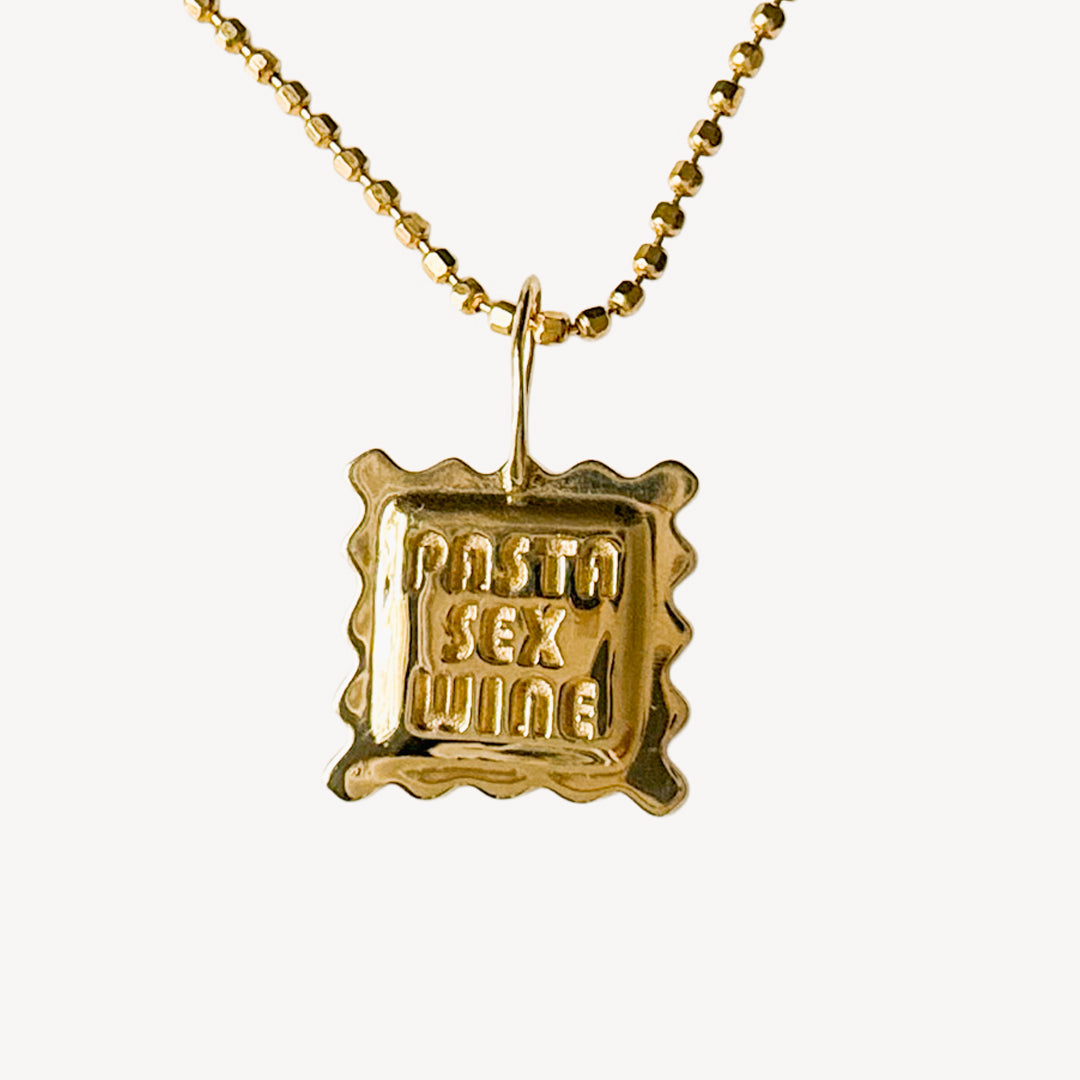 14k solid gold ravioli charm necklace engraved with "Pasta Sex Wine" on white background